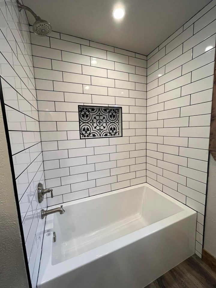 Bathtub with white subway tile shower surround
